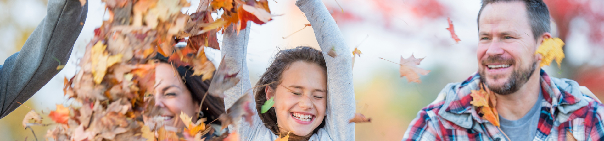  Family throwing autumn leaves 